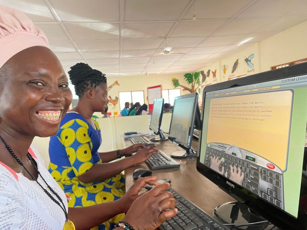 A group of young women in Ghana in a computer training room.